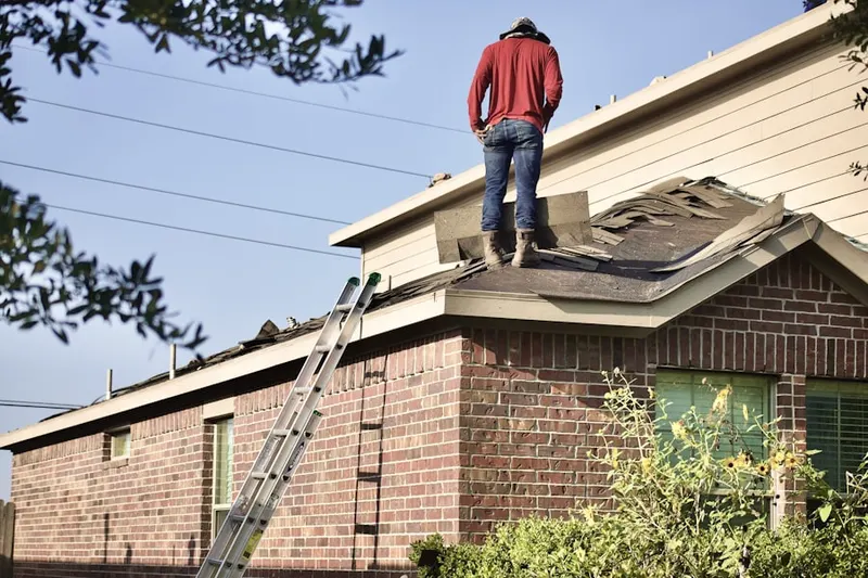Professional roofer working on a residential roof in Clear Acres